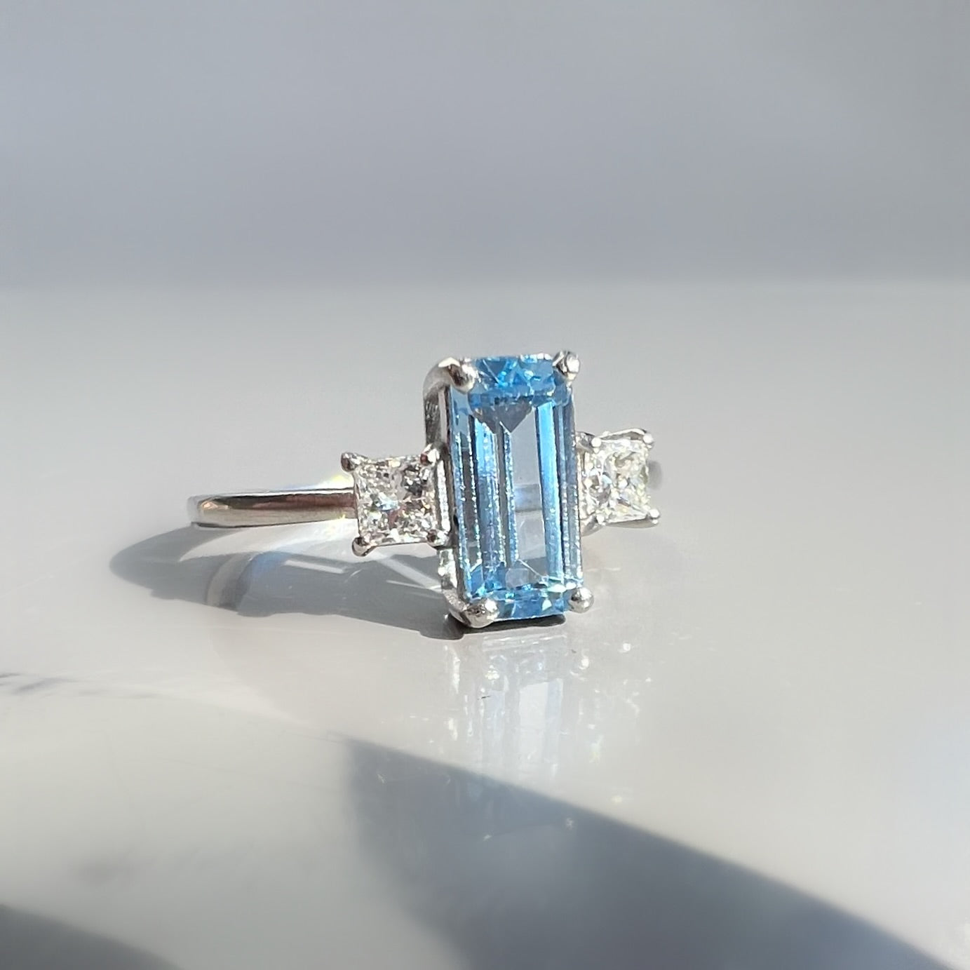 0.80ct Aquamarine and 0.26ct Princess Cut Diamond 3 Stone Ring