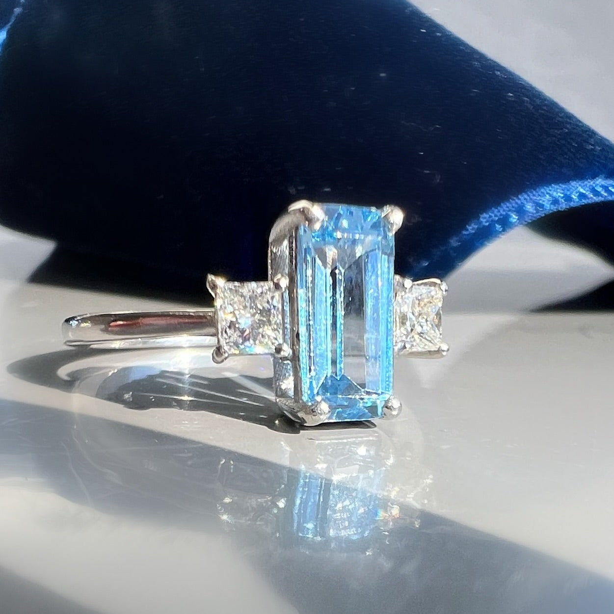 0.80ct Aquamarine and 0.26ct Princess Cut Diamond 3 Stone Ring